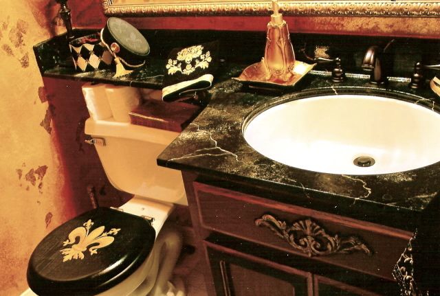 Marbleized counter, painted cabinet, toilet seat, gold faux walls